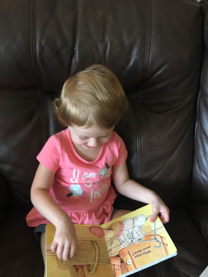 Fostering against stereotypes - pic of tiny girl reading a book