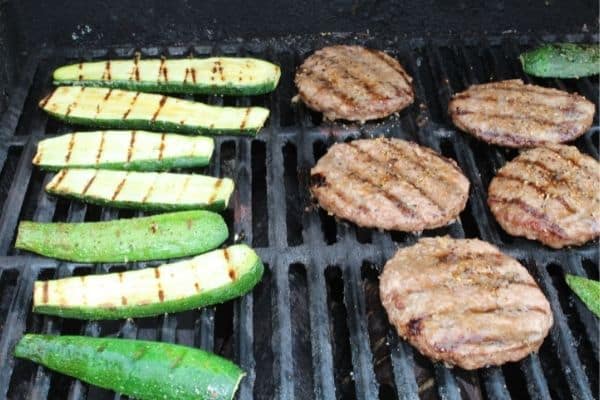 grilled zucchini on the grill with hamburgers