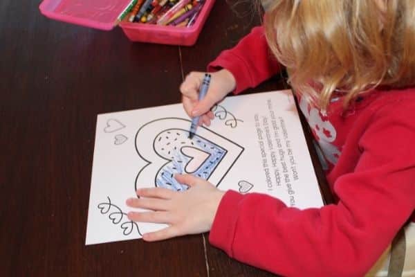 Child coloring a Children's Valentine's Day Poem for parents