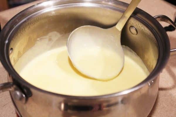 Gluten free cheese sauce recipe - cheese shown melted in pot.