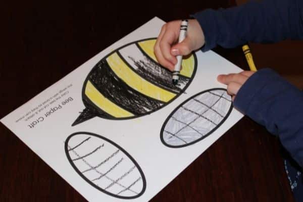 Child coloring paper bee craft