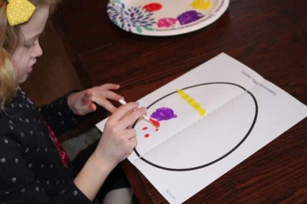 Child painting an symmetry easter egg template