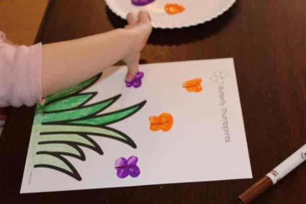 Child thumbprinting a butterfly