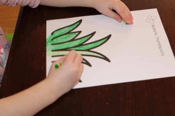 Child coloring the thumbprint butterfly template 