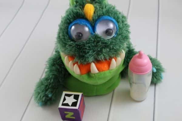 Feed the Monster Circle time activity - monster puppet shown with letter B objects including a block and a bottle