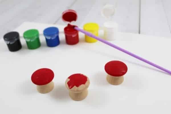 Wooden mushrooms being painted red