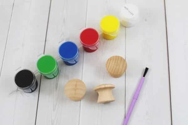 wooden drawer pulls, a paint brush and acrylic paint set