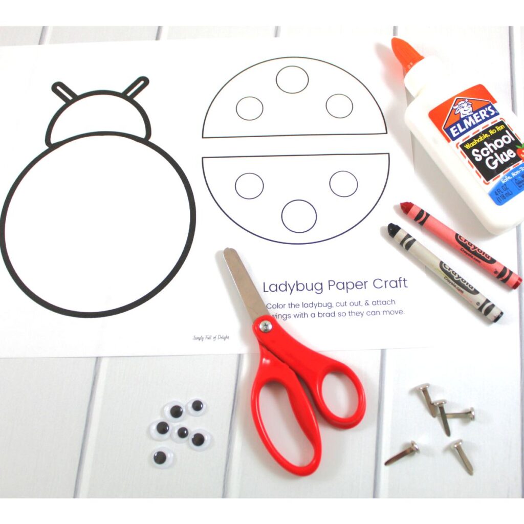 Supplies for easy ladybug craft includes free ladybug template, crayons, scissors, glue, brads, googly eyes