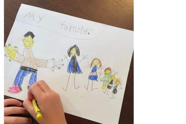 Child drawing a family portrait