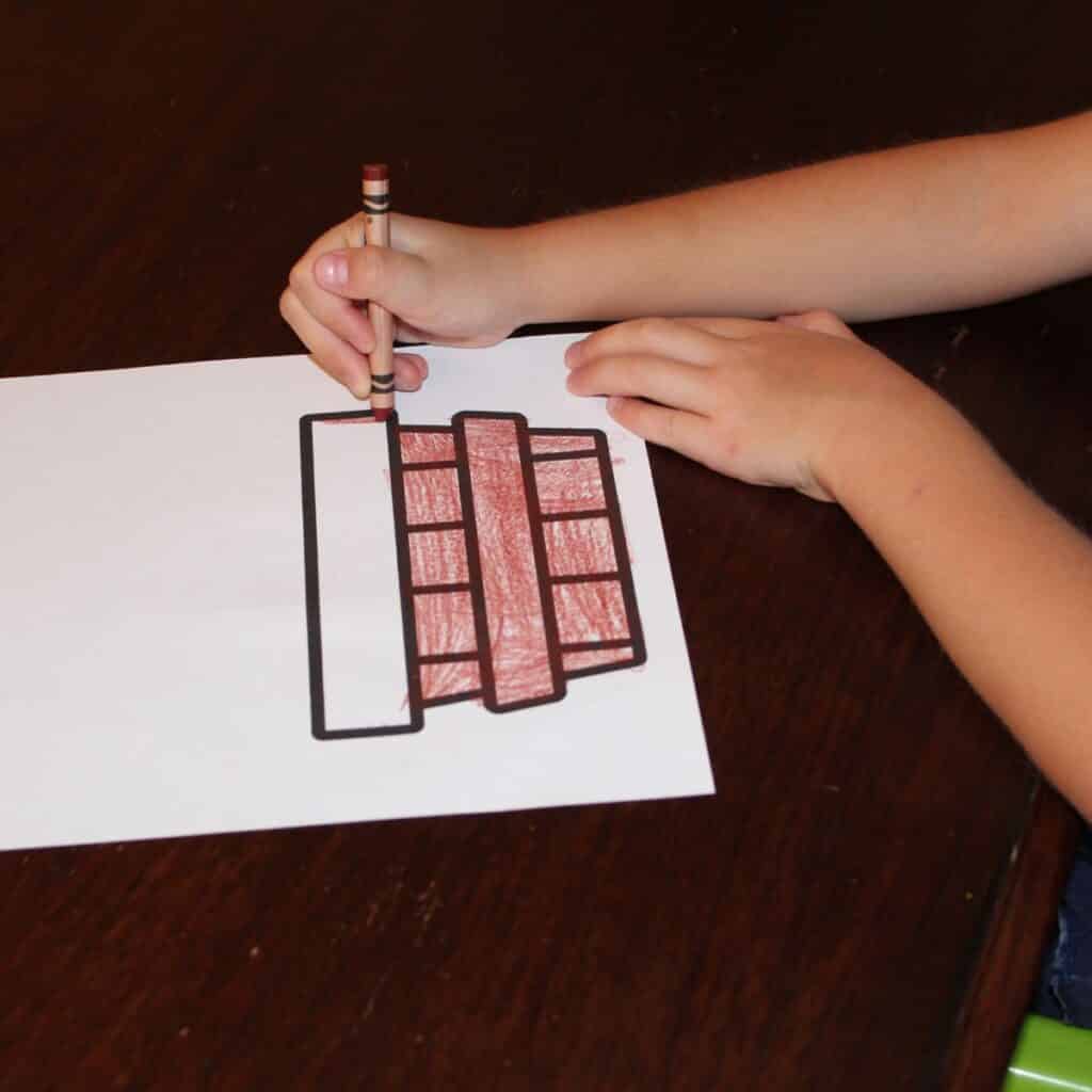 child coloring the apple basket printable for apple stamping.