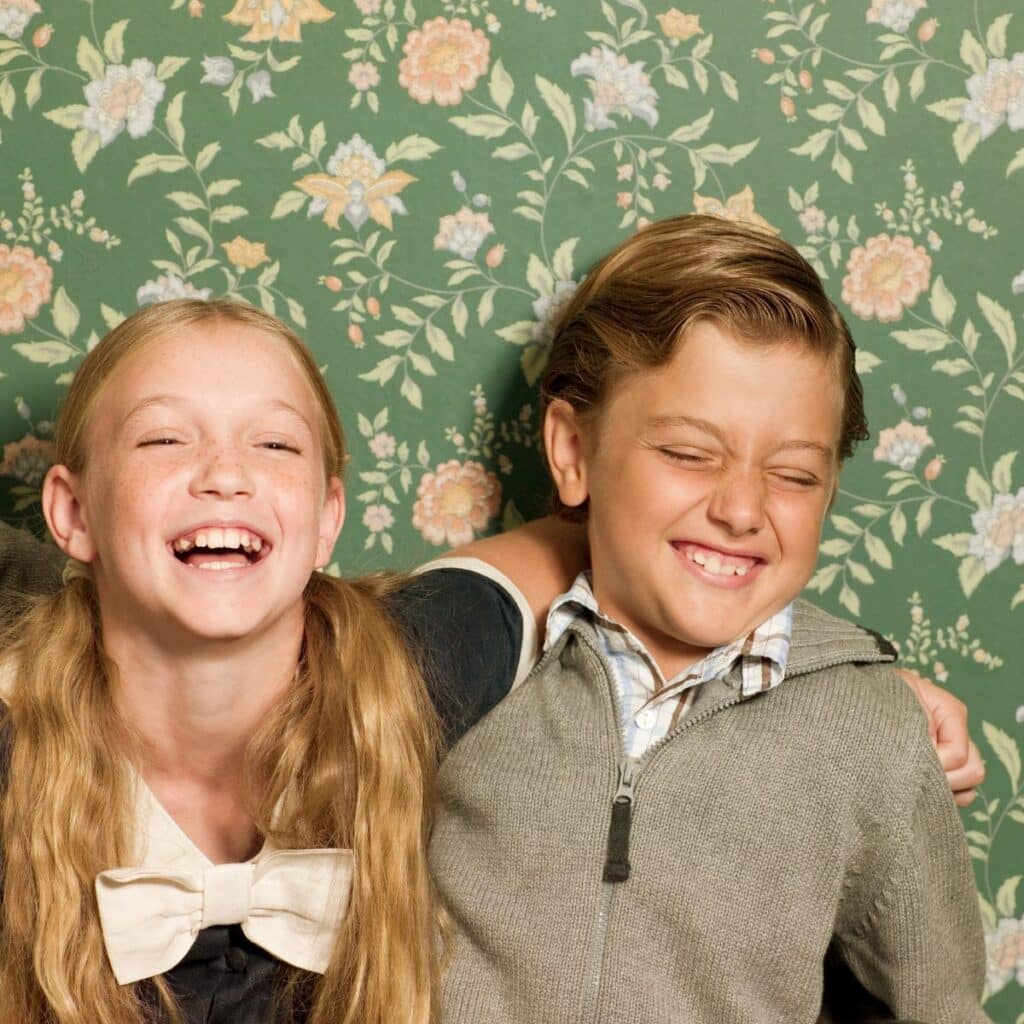 Fun questions for kids - a brother and sister laughing together