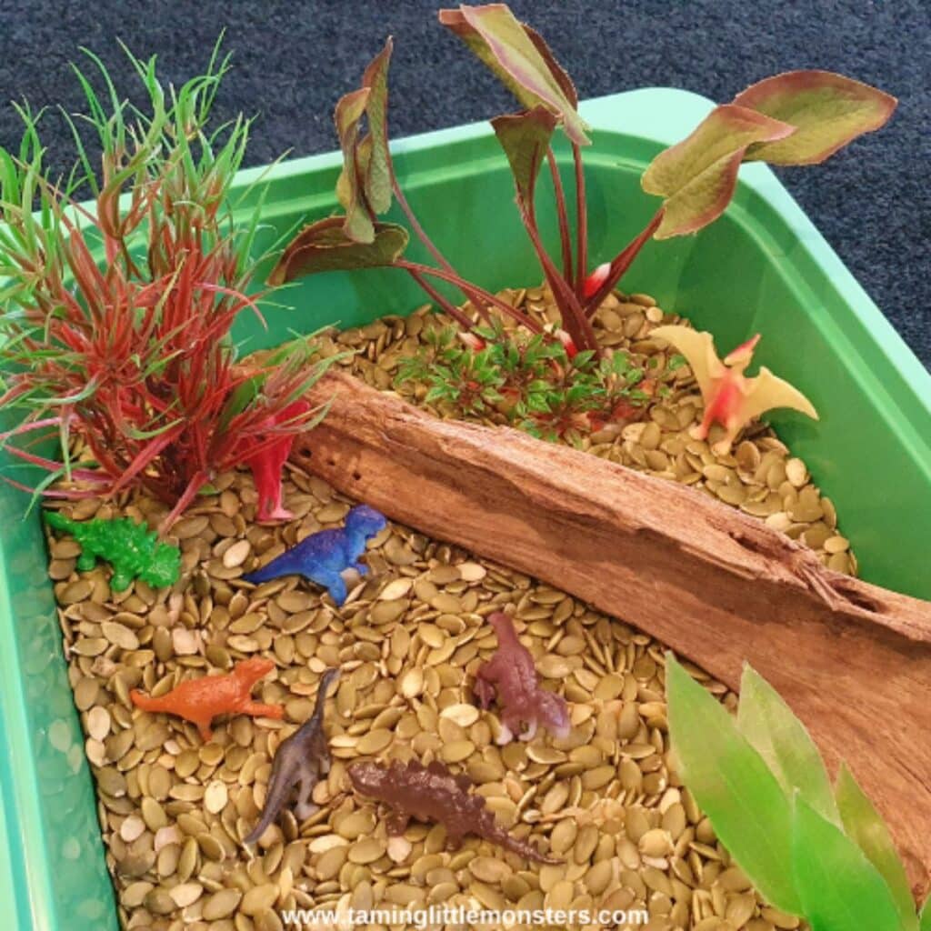 easy dinosaur sensory bin by Taming Little Monsters