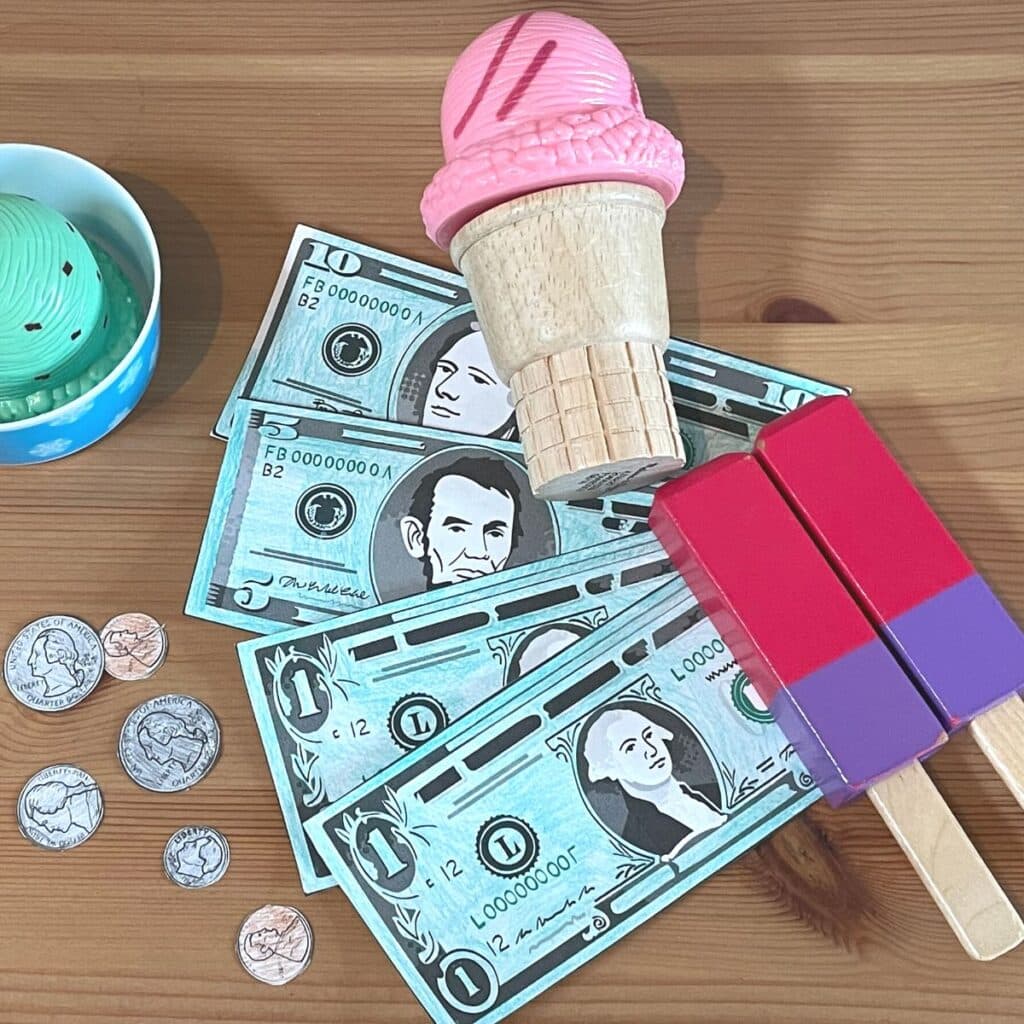 Free printable money templates shown colored with toys to create an ice cream shop