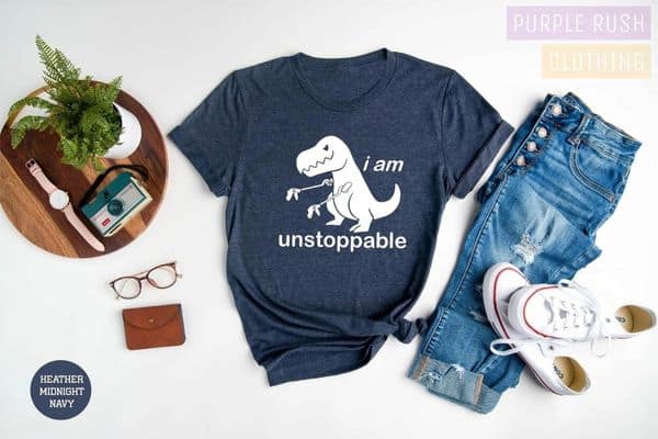 dinosaur shirt by Purple Rush Clothing - features a funny dinosaur with grabbers in each hand and words say i am unstoppable