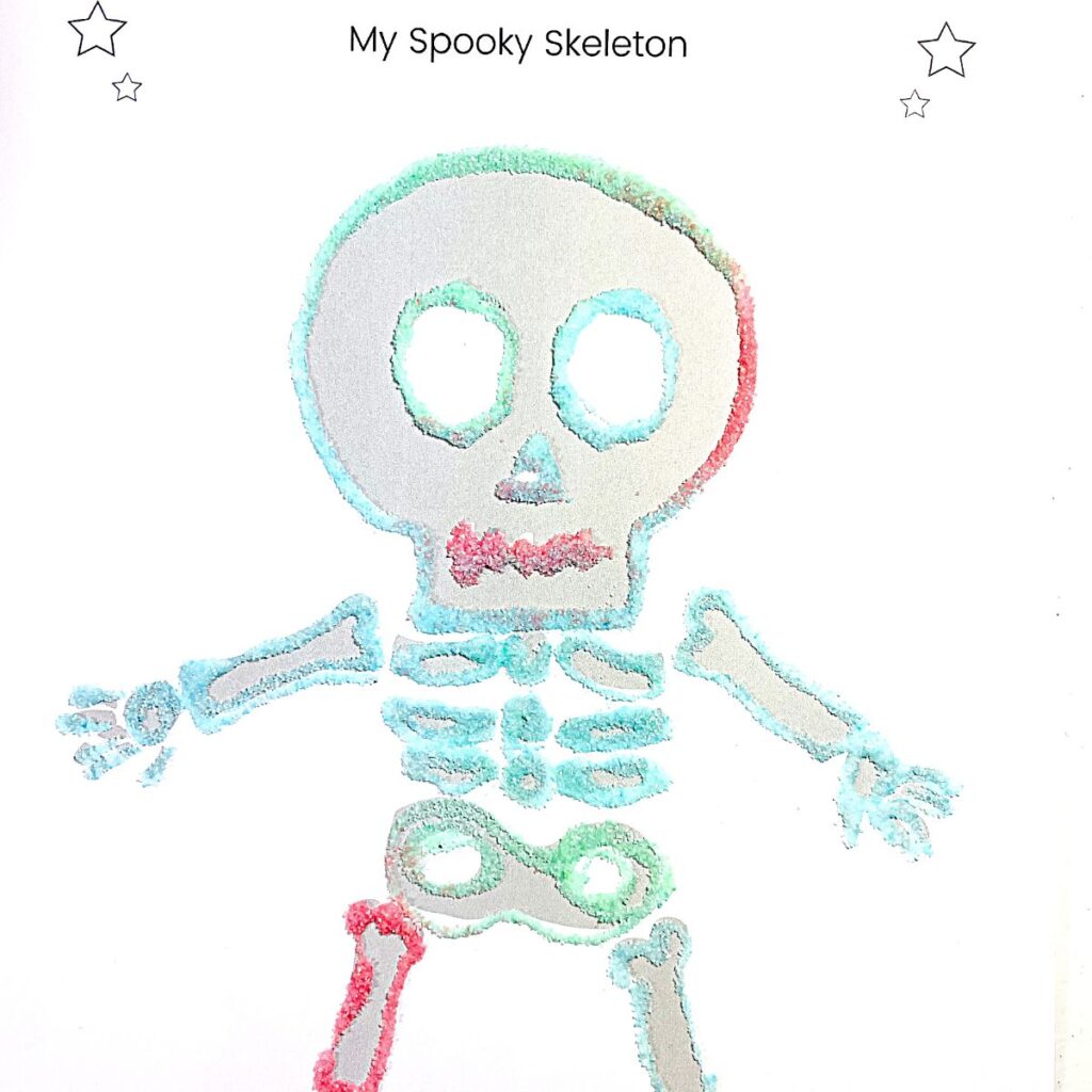 My Spooky Skeleton craft for preschool - completed - free skeleton template covered in colored sand art