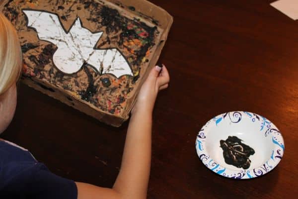 child marble painting a bat - ball painting for preschool activity