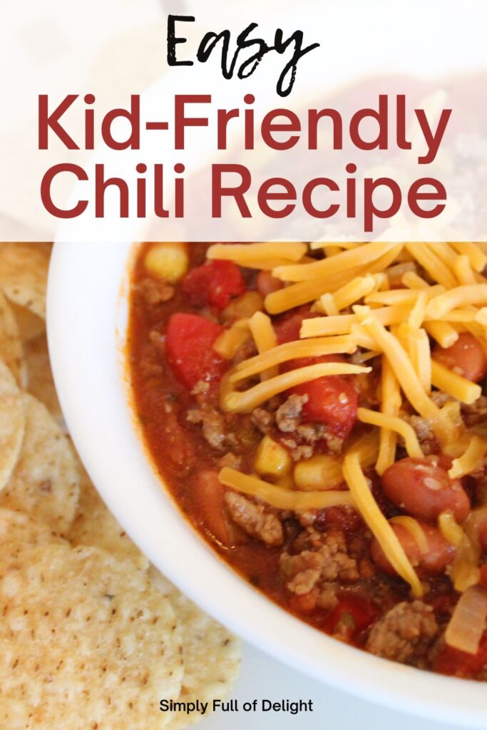 Easy Kid Friendly Chili Recipe - an awesome easy chili recipe that is family friendly.  Shown: bowl of kid-friendly chili soup topped with cheddar cheese and a side of tortilla chips