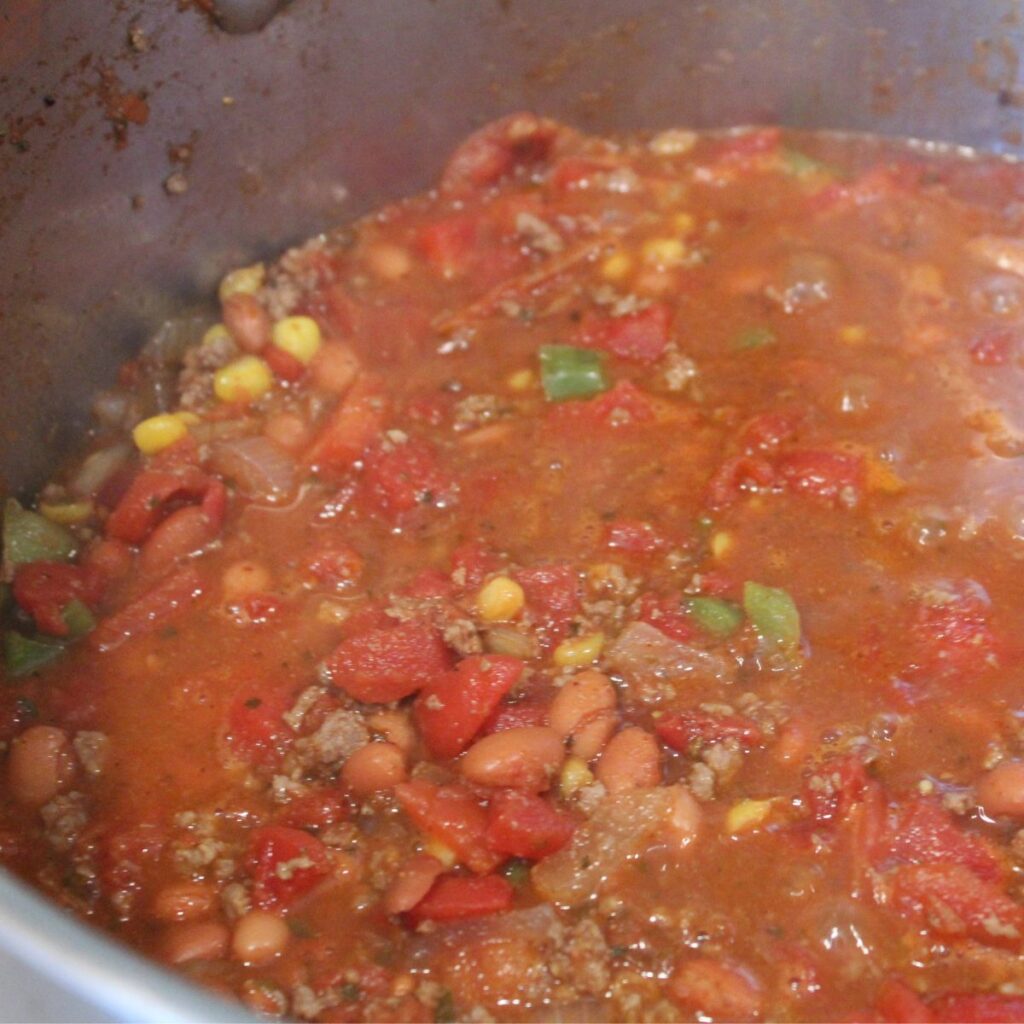 kid-friendly chili recipe simmering on the stove in a pot