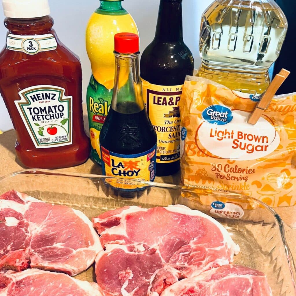 Ingredients for Gluten Free Pork Chops - shown: pork chops, ketchup, soy sauce, lemon juice, canola oil, brown sugar, and Worcestershire sauce