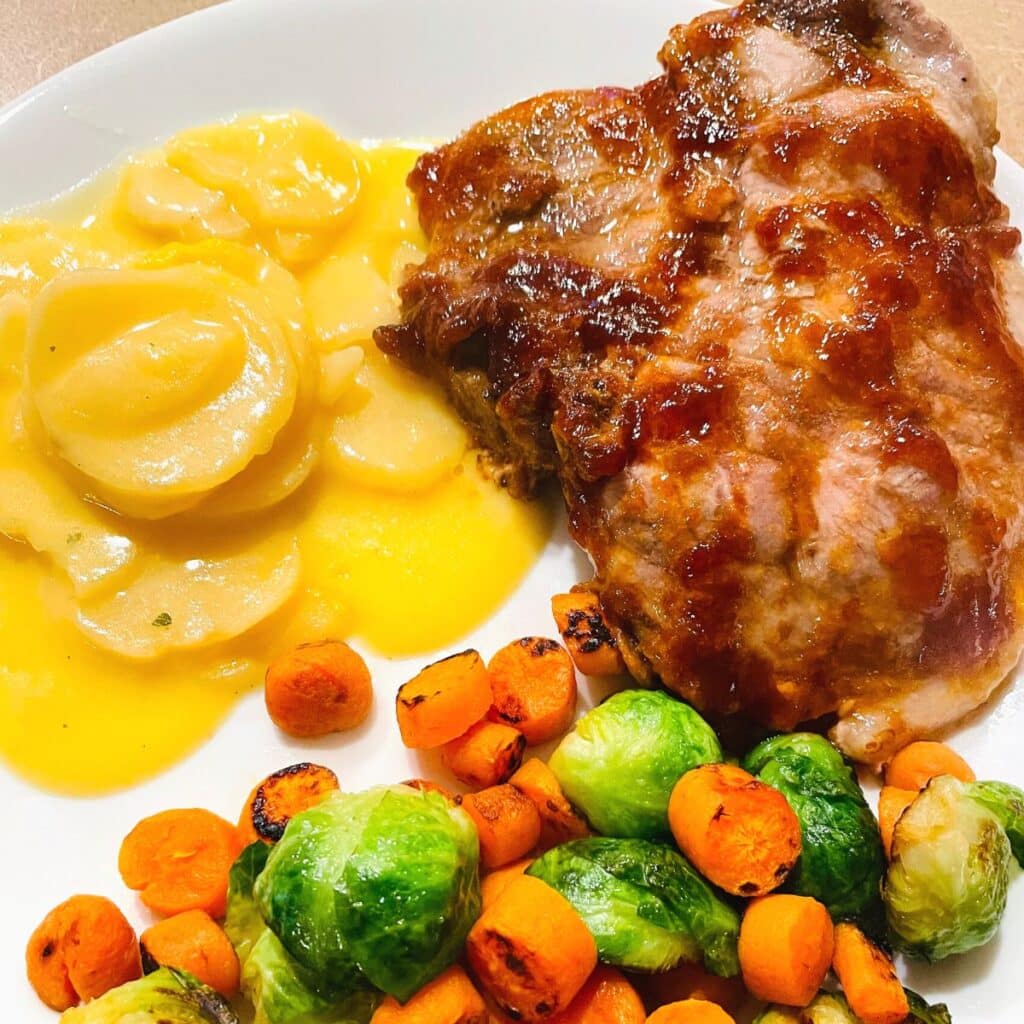 Side dishes for gluten free pork chops include au gratin potatoes and Brussel Sprouts and Carrot sauté