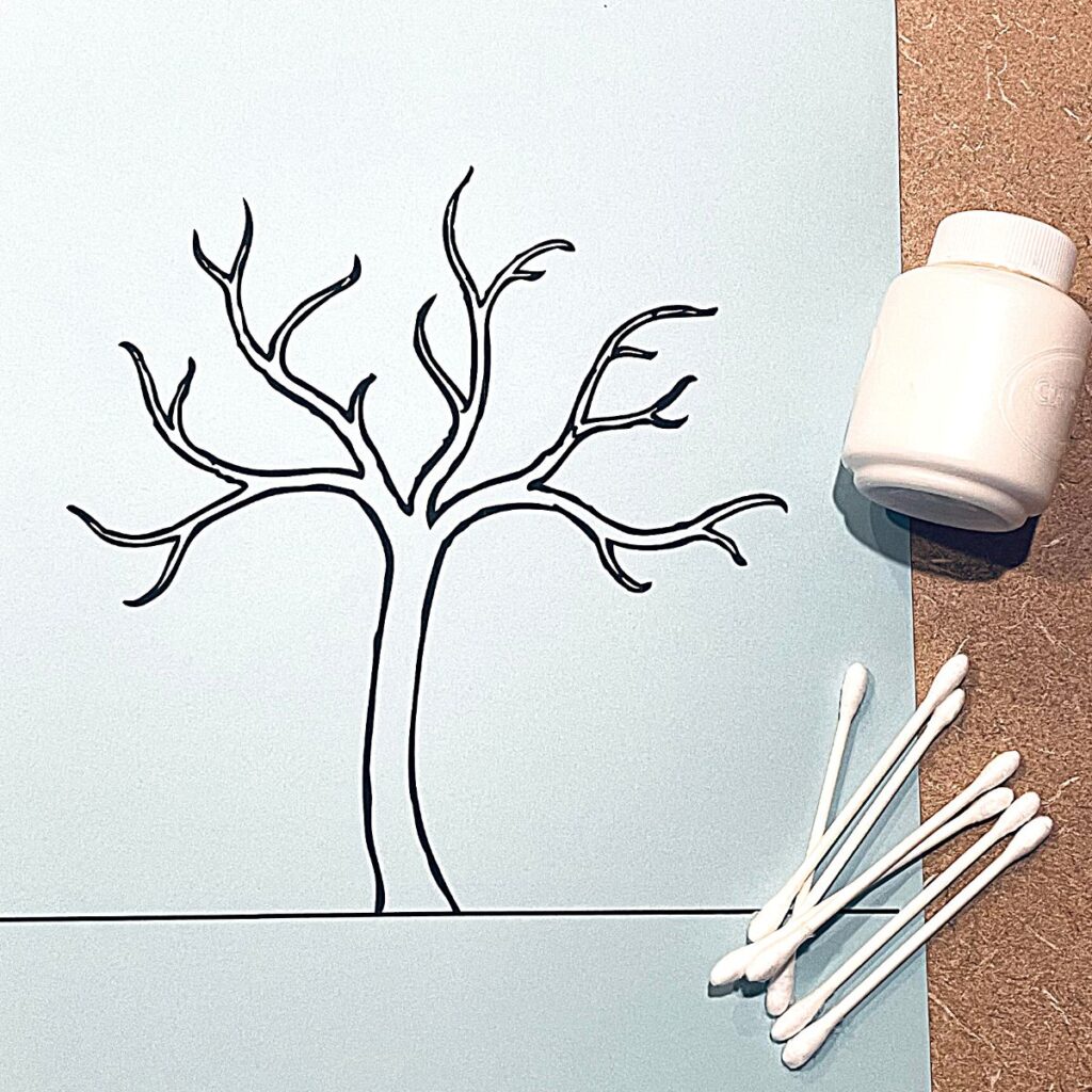 winter tree printable on blue paper with cotton swabs and white paint