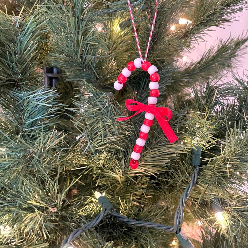 beaded candy cane ornament diy hanging on a christmas tree