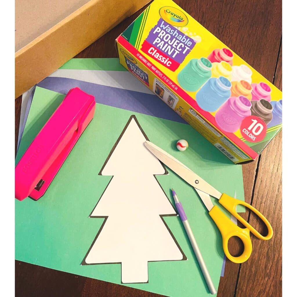 supplies for winter tree craft including crayola washable paint, a winter tree template, stapler, construction paper, box, marble, scissors, pen