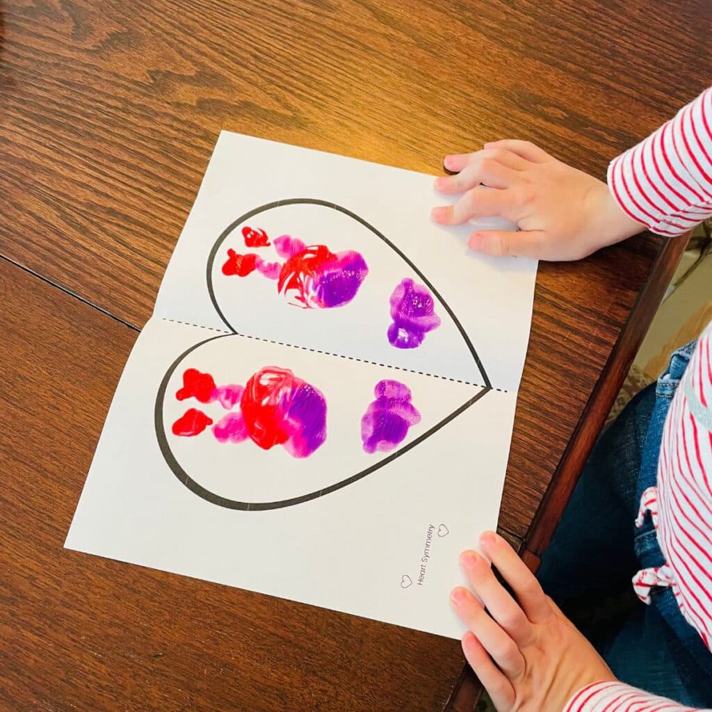 a completed symmetry heart art project for kids