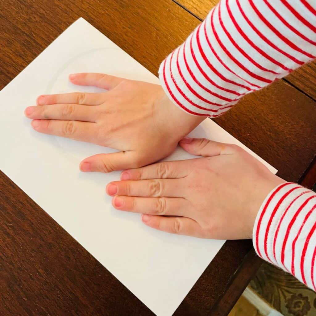 child pressing down page for a symmetry heart craft