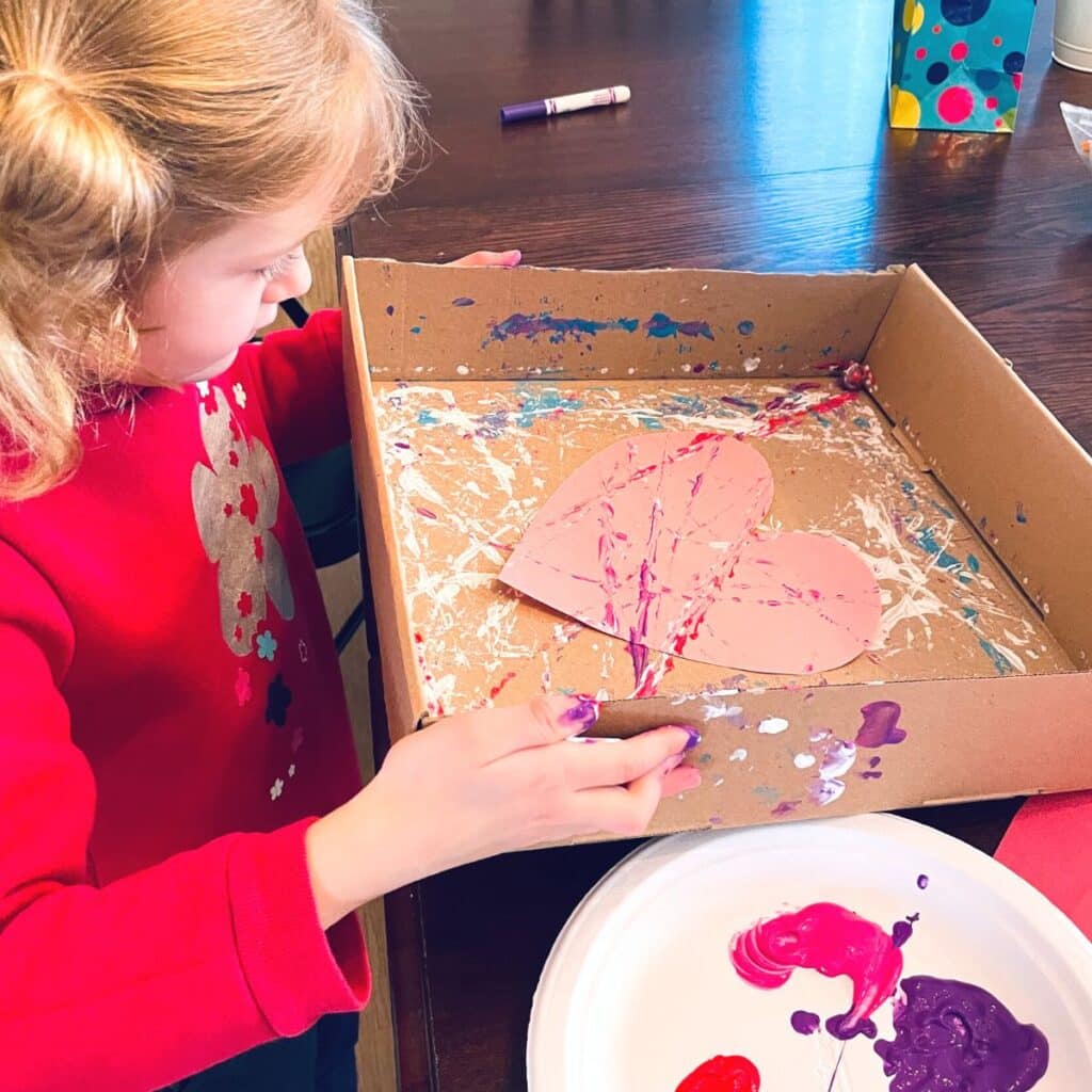 child holding box to marble paint