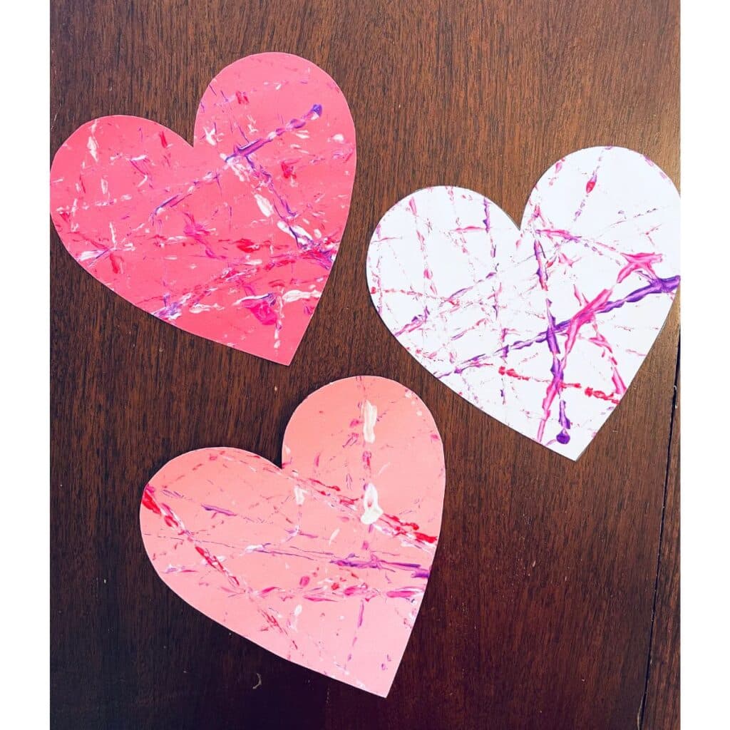 heart marble paint art - 3 hearts shown marble painted (red, pink and white)