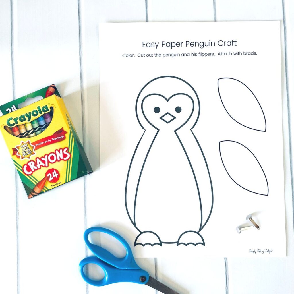 easy paper penguin craft supplies:  the free printable penguin, crayons, scissors and brads