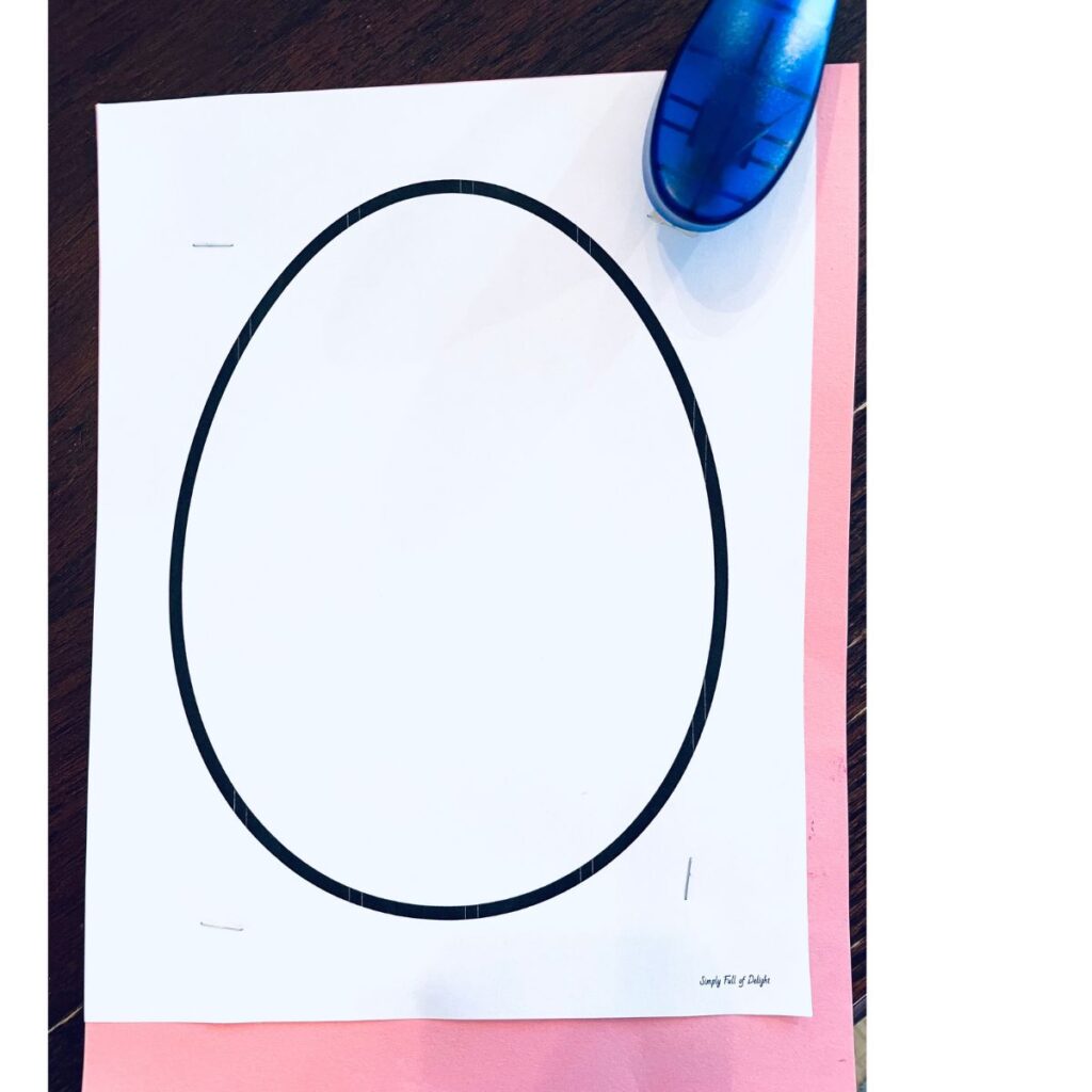 egg template stapled to stack of construction paper