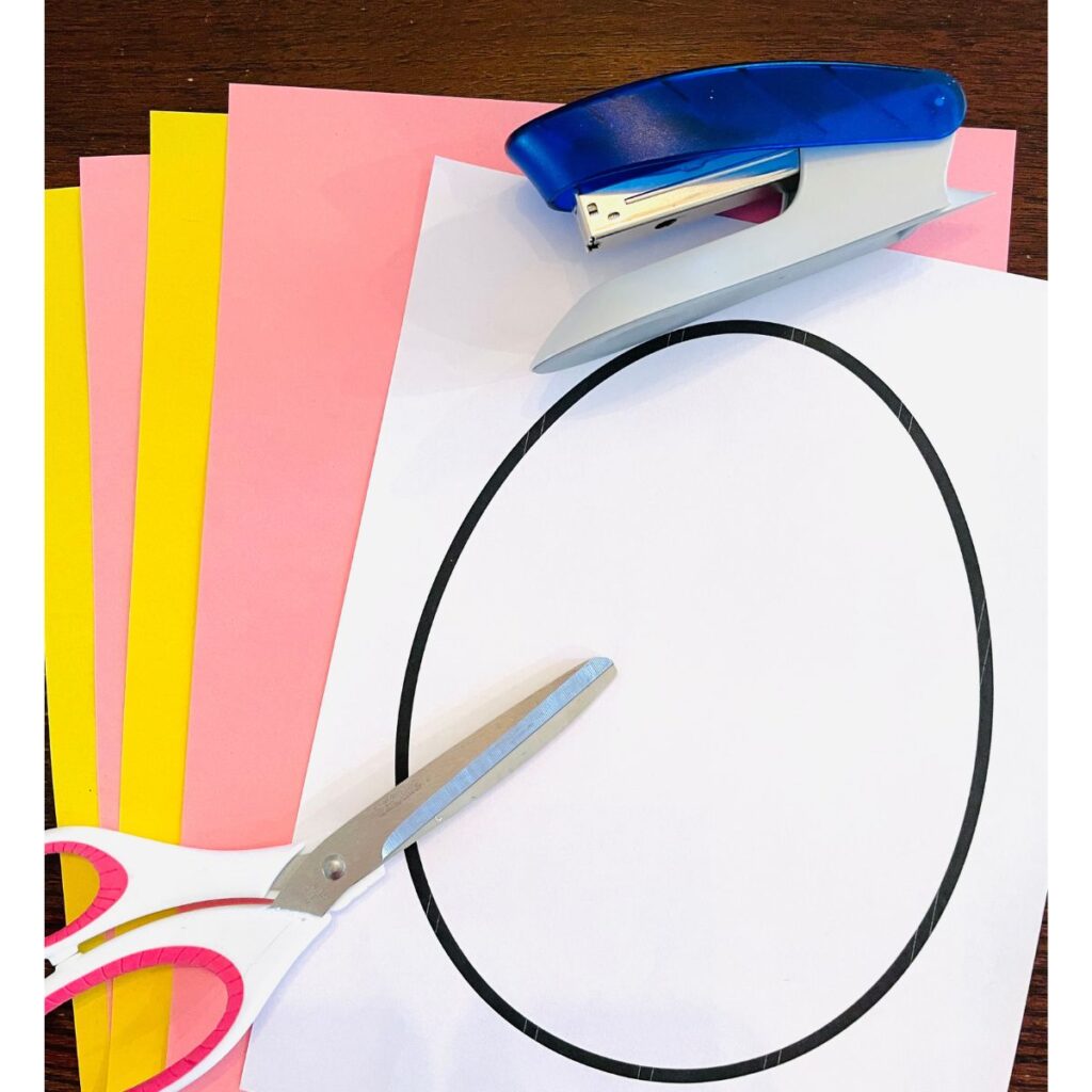 Marble Painting Easter Egg Craft supplies including an egg template, scissors, construction paper and stapler