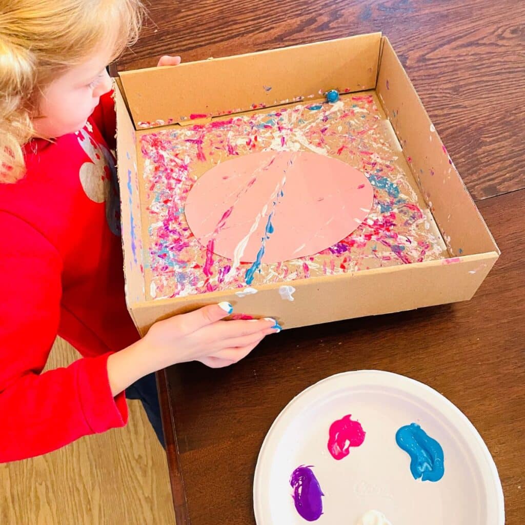 child moving box to marble paint an easter egg printable