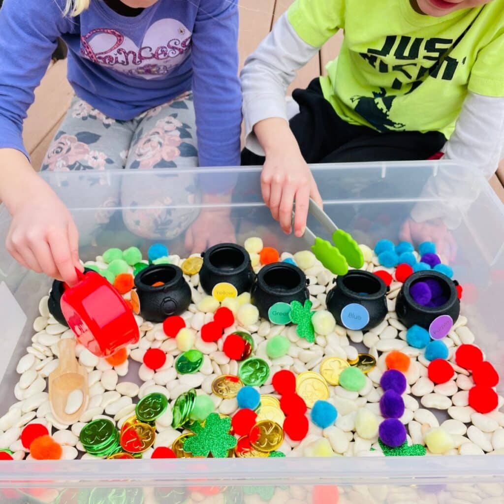 kids playing with st patricks day sensory bin