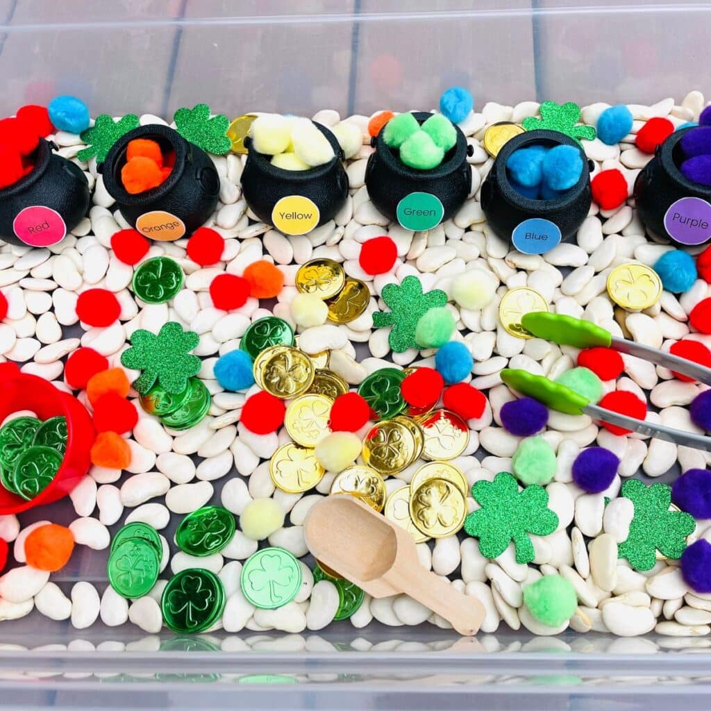 St. Patrick's Day sensory bin - a fun color sorting Saint Patrick's Day sensory activity - kids sort pom poms by color into pots of gold.