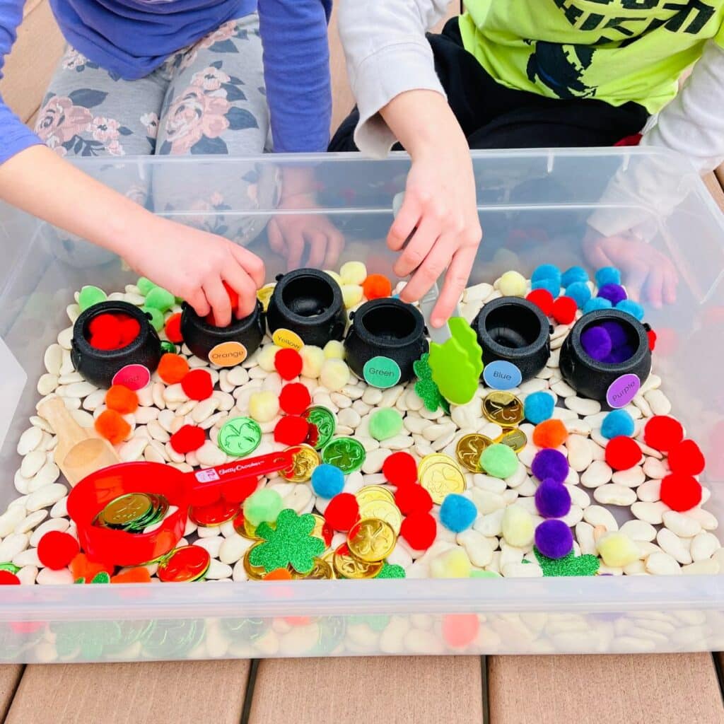 kids playing in a sensory table for saint patricks day