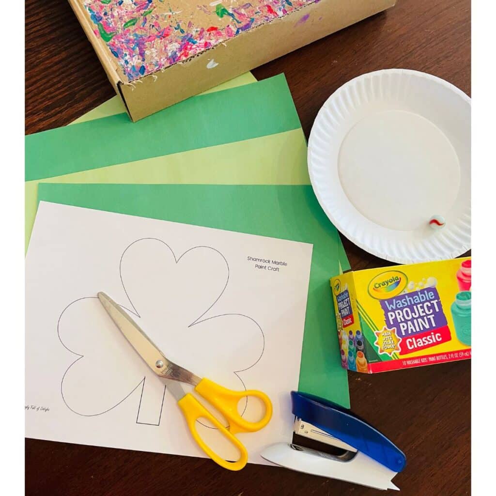 supplies for preschool shamrock craft - marble, paint, colored paper, shamrock template, scissors, paper plate, stapler