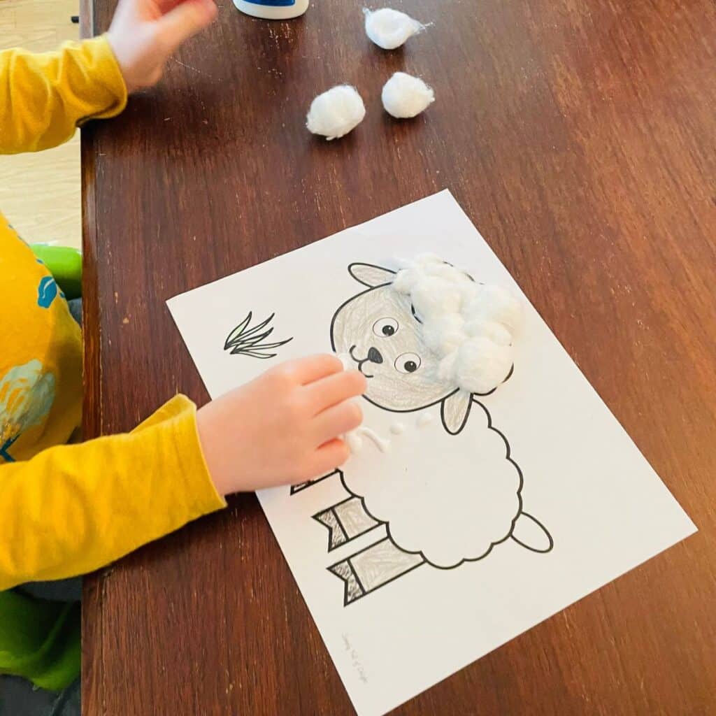 sheep craft - child adding cotton and glue