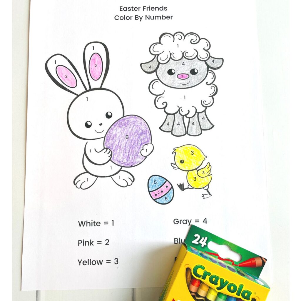 An easter themed color by number page featuring the easter bunny, a chick, and a lamb - shown colored in with crayons.