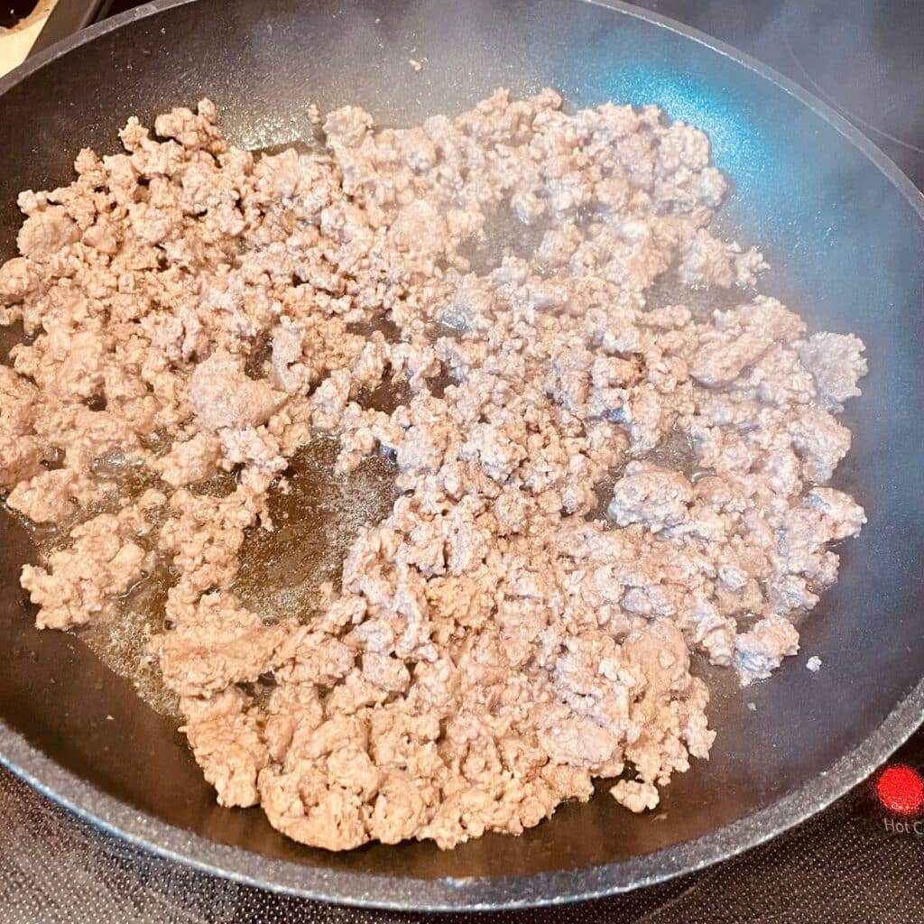 ground beef browning in a skillet