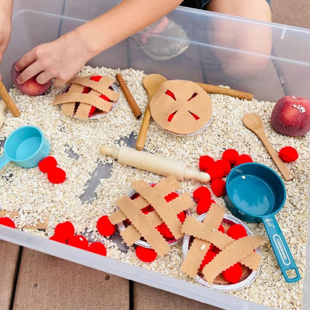 child playing with apple pie sensory play idea