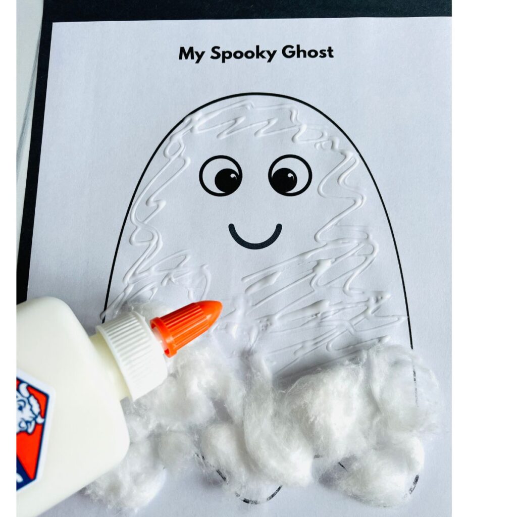 adding more cotton to the cotton ball ghost craft