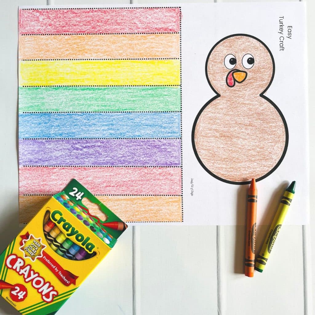 thanksgiving turkey craft template colored with rainbow colored feathers and a brown body.