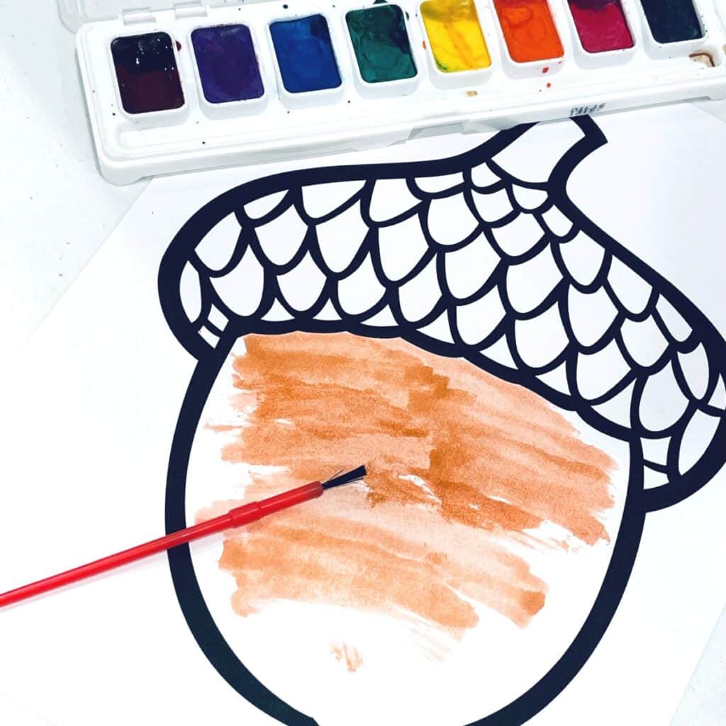 painting the bottom of the acorn printable with watercolors