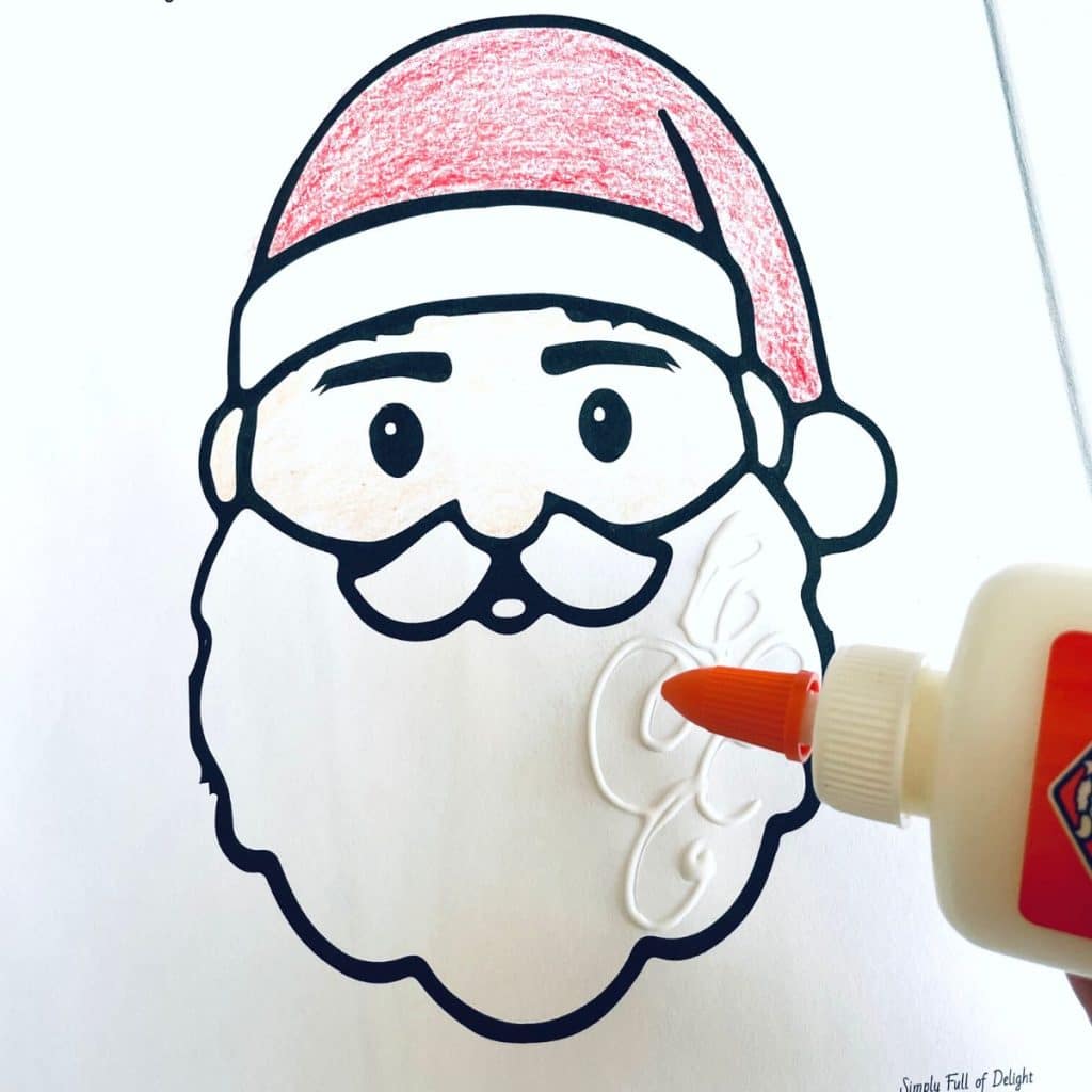 adding a bit of glue to the santa beard