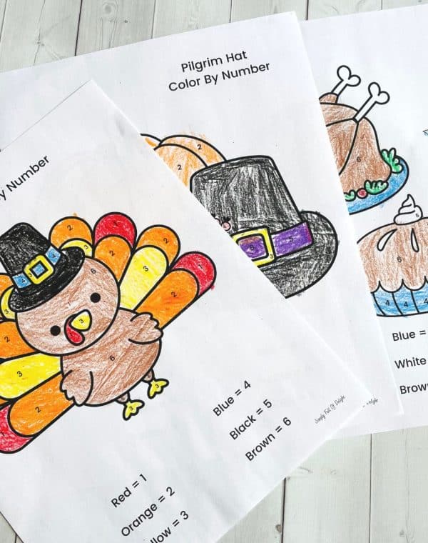 Thanksgiving color by number printables including a turkey, pilgrim hat and a Thanksgiving feast
