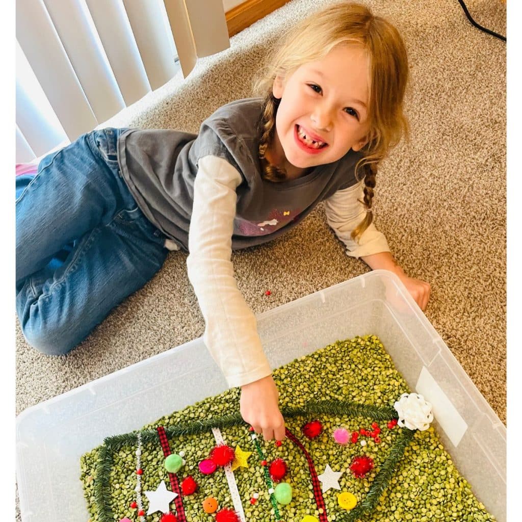 child playing with Christmas sensory bin