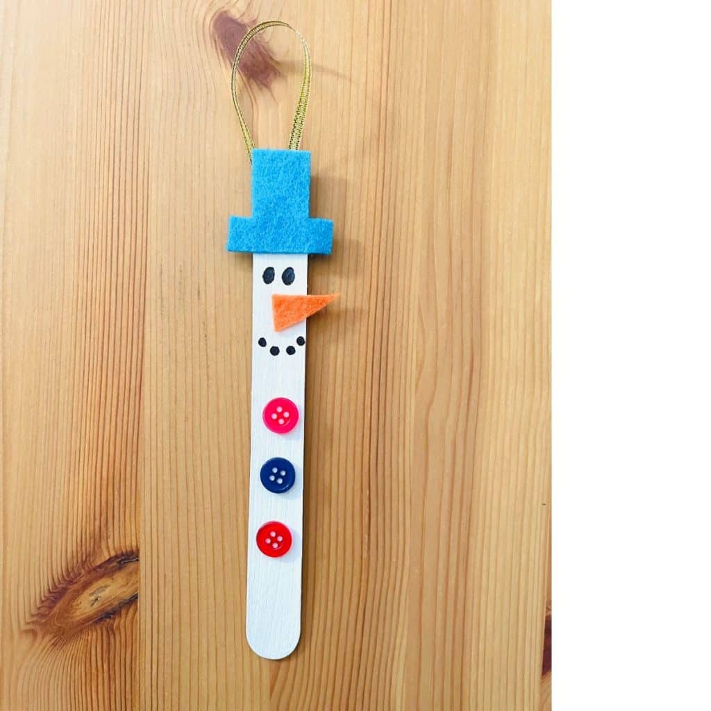 snowman ornament craft on wooden table